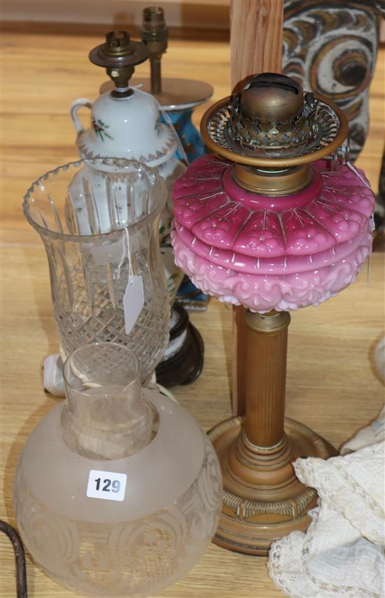 A brass and pink opaline glass oil lamp with etched glass shade and three table lamps, various,